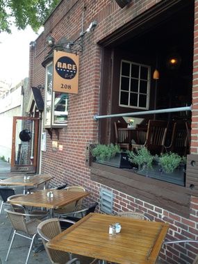Exterior of Race Street Cafe, with outdoor tables and chairs set up outside the restaurant's open air window