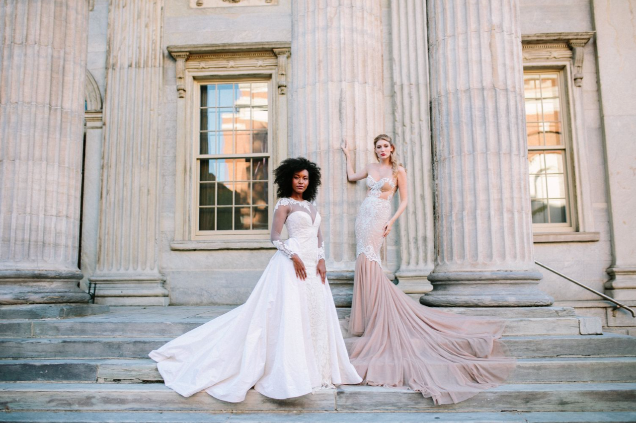 Two people wearing wedding gowns