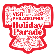Logo of Visit Philadelphia Holiday Parade in red text inside red Liberty Bell outline