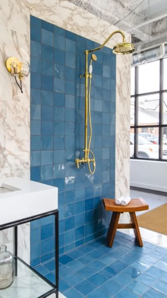 Interior of Nemo Tile + Stone with blue tile and marble sink on display