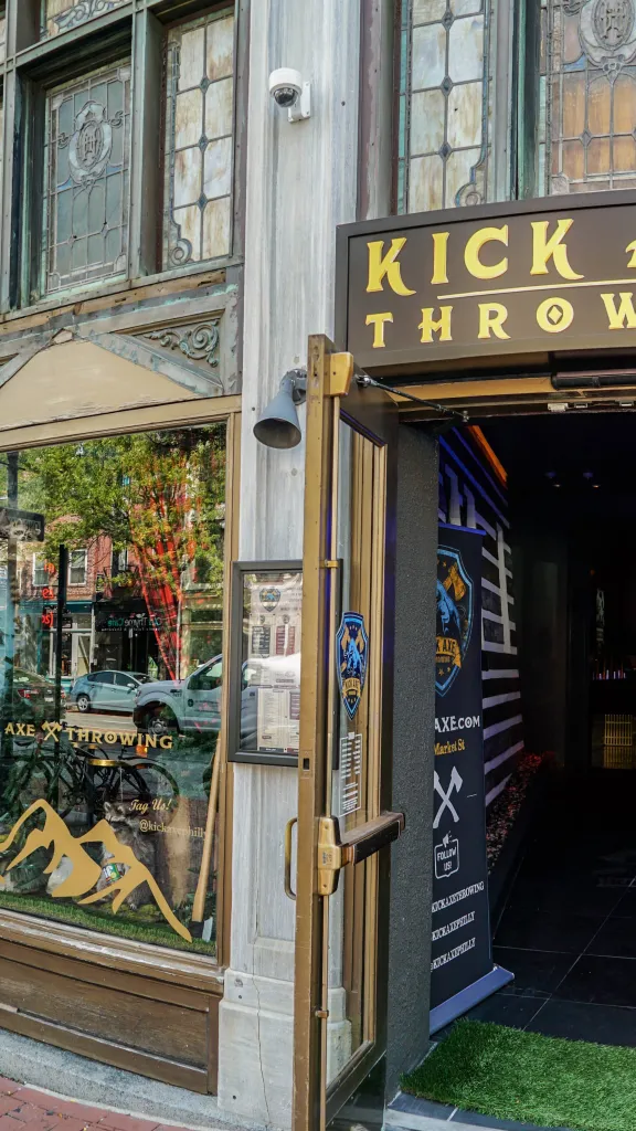 Exterior of Kick Axe Throwing with open front door and large front display windows