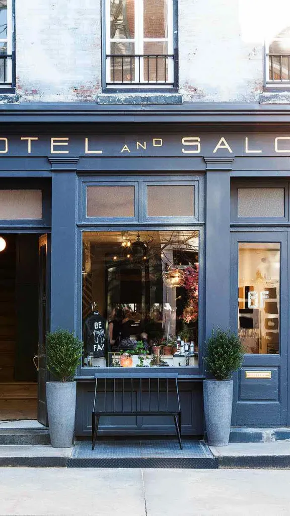 Exterior of Lokal Hotel with "Hotel and Salon" signage above and front door to hotel