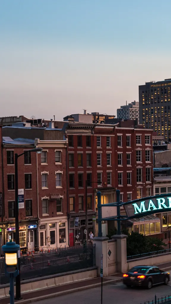 A skyline view of Market Street with the illuminated Market Street sign at the overpass