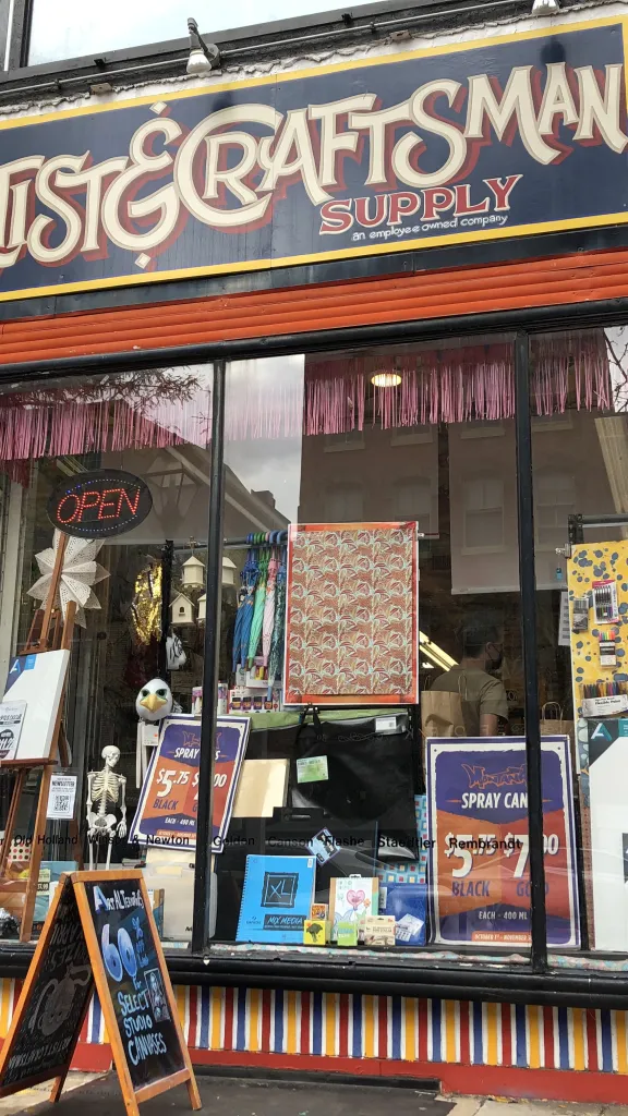 Exterior of Artist & Craftsman Supply, with front entrance and large window display