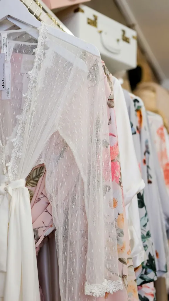 Interior of Chick Invitations with rack of clothing on display