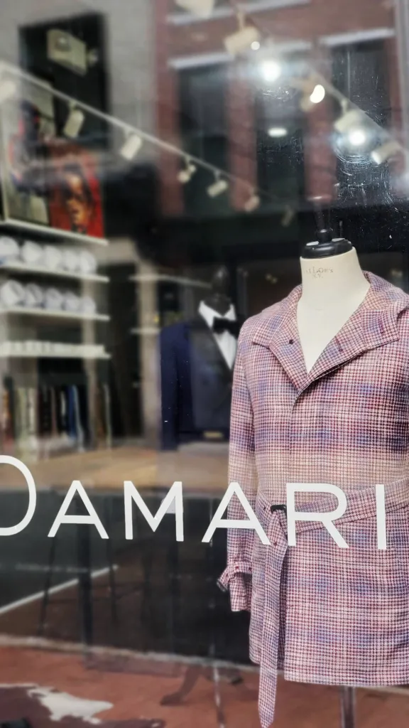 Clothing on display in front window at Damari