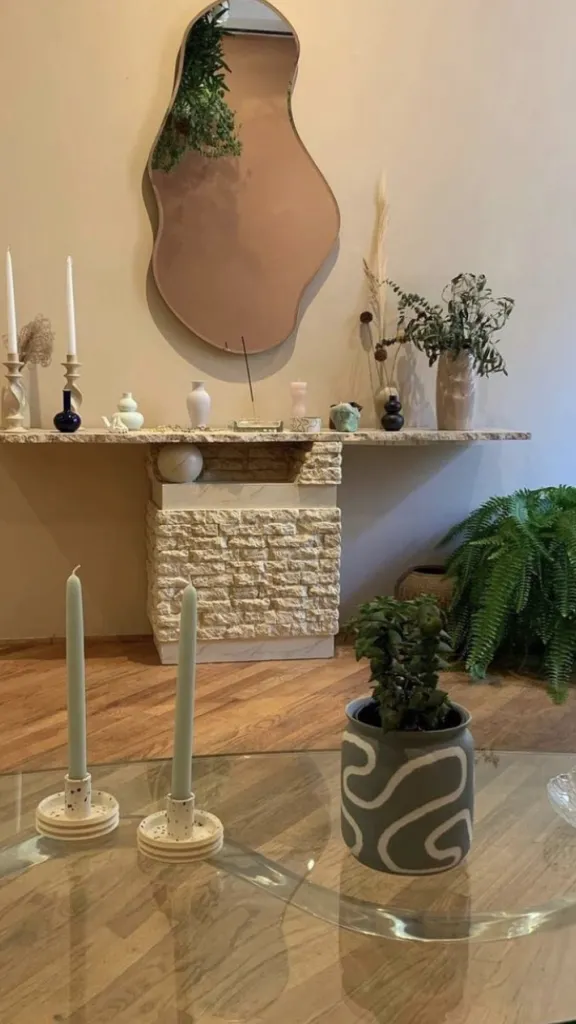 Interior of Casa Vida shop with mirror on wall and items on display as well as table with items on display and a plant