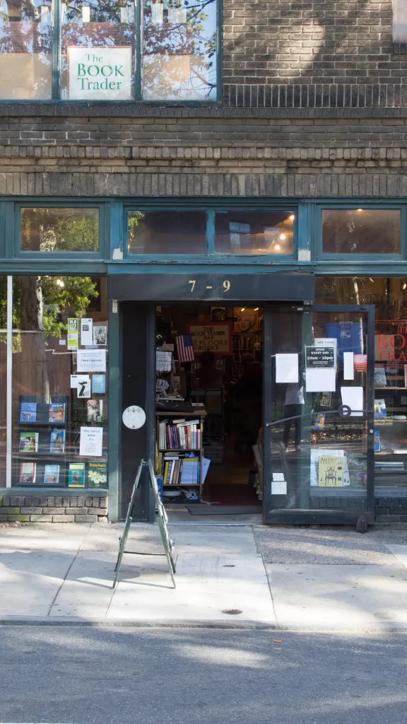 Exterior photo of The Book Trader shop on N. 2nd Street in Old City, Philadelphia with books on display outside and in front windows