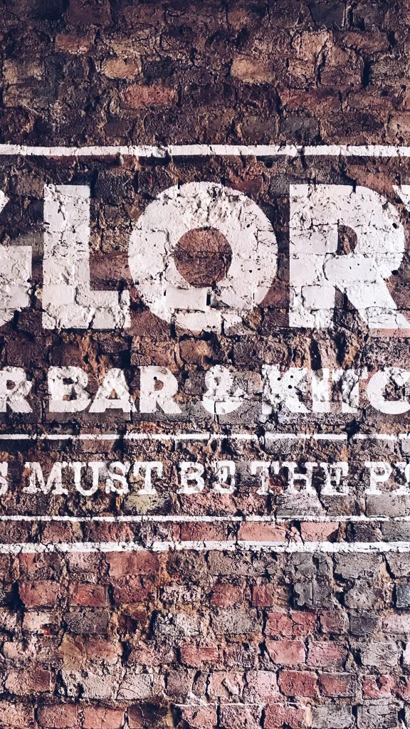 Glory Beer Bar & Kitchen logo on brick wall