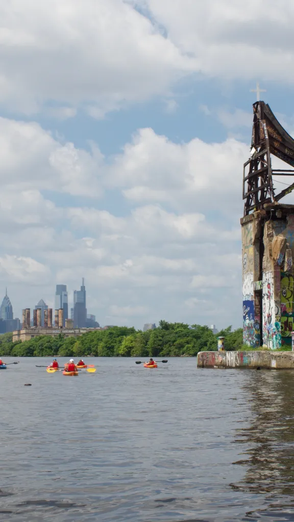 People kayaking in the Delaware River near Graffiti Pier