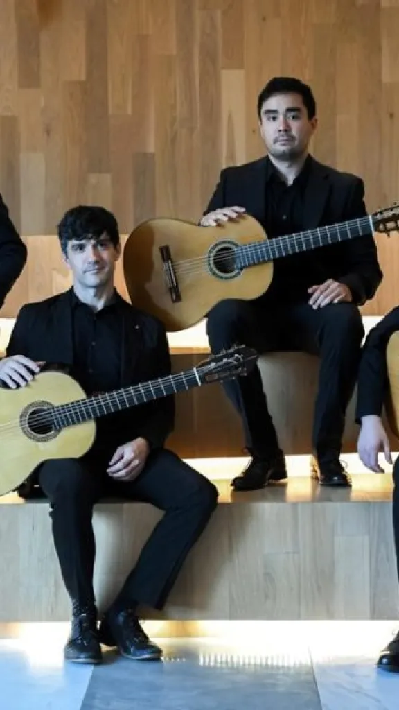 Members of New York City Guitar Quartet seated on steps
