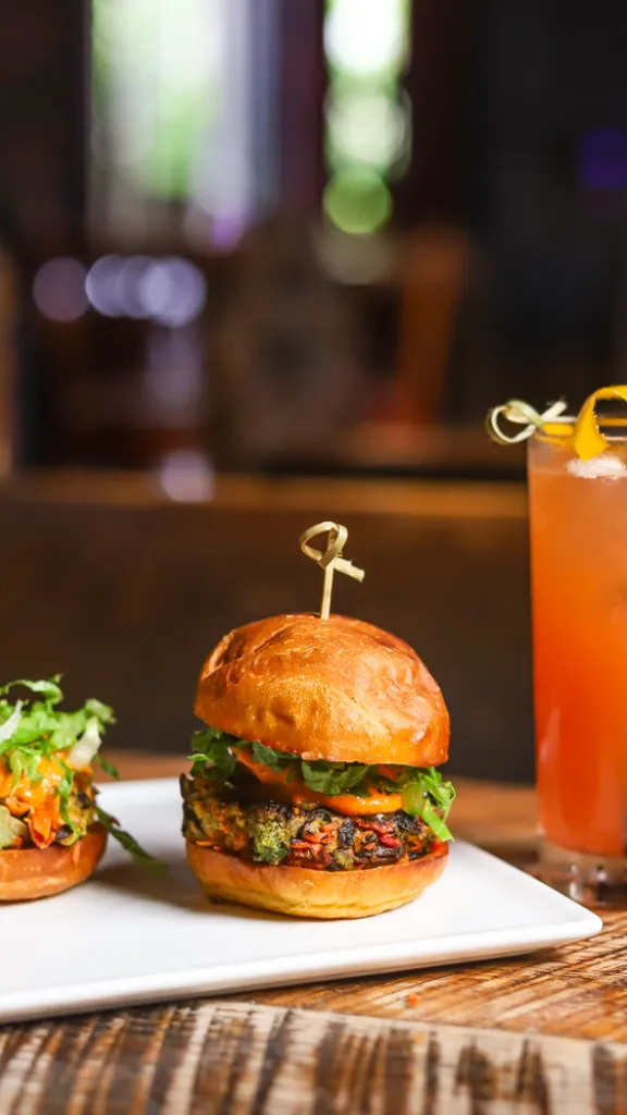 Two sliders and a drink on display at National Mechanics