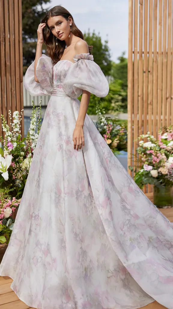 Person wearing bridal gown standing in front of flower bouquets 