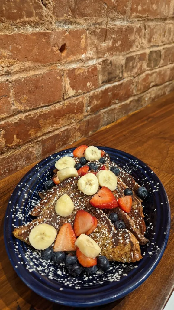 French toast with fruit on a plate at the cafe