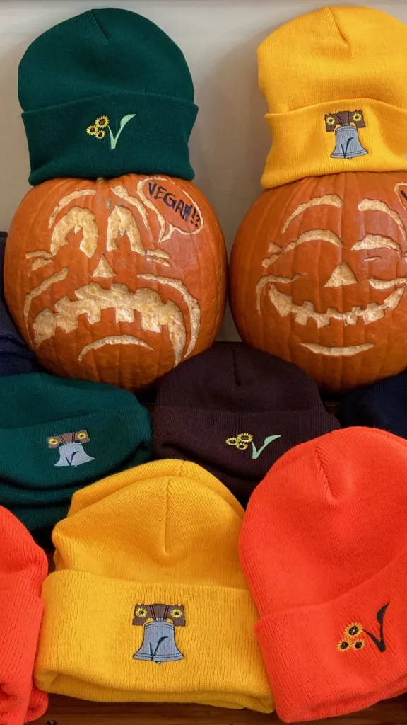 Two pumpkins with American Vegan Center hats