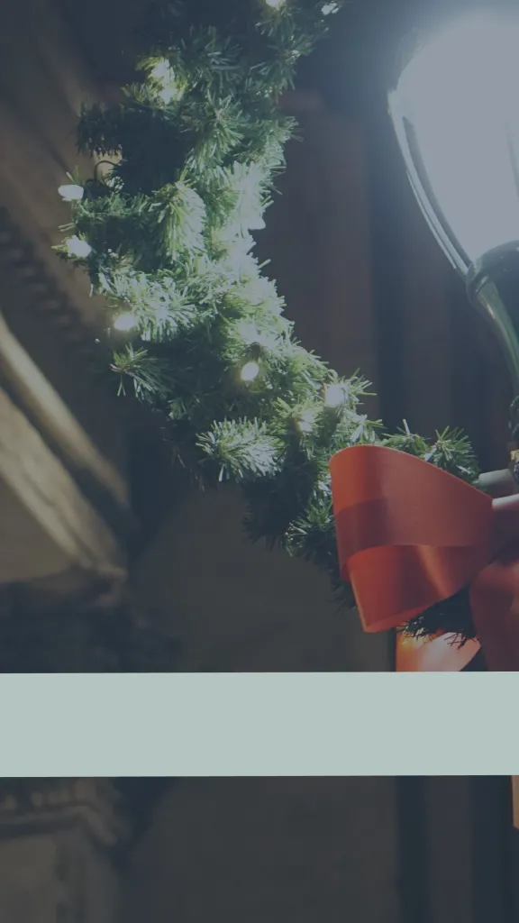 Illuminated holiday wreath with "Old City Holiday Pass" logo in bottom left corner