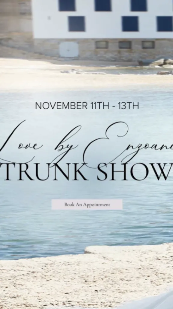 Two people wearing bridal gowns standing on beach