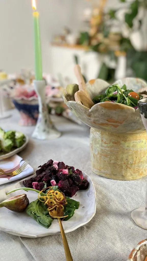 Table with plates of food, candle, and other decor