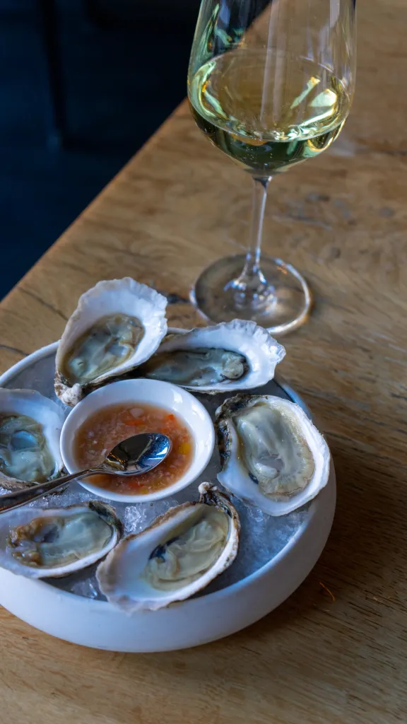 Oysters and a glass of wine on display