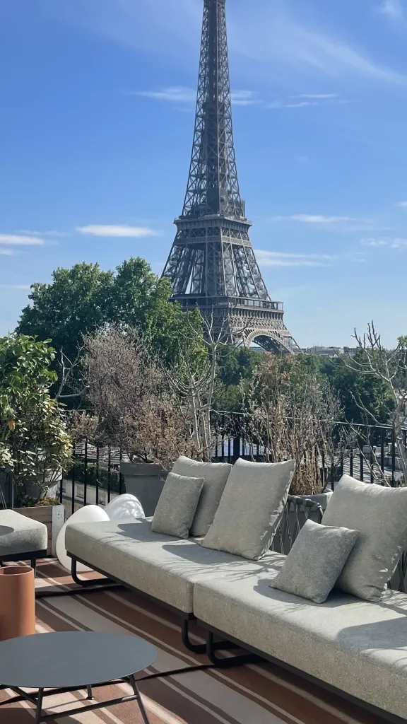 Outdoor patio with furniture overlooking the Eiffel Tower