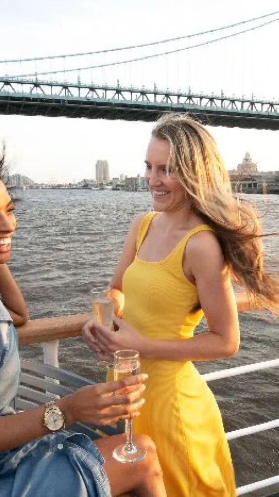 Two women enjoying drinks on cruise