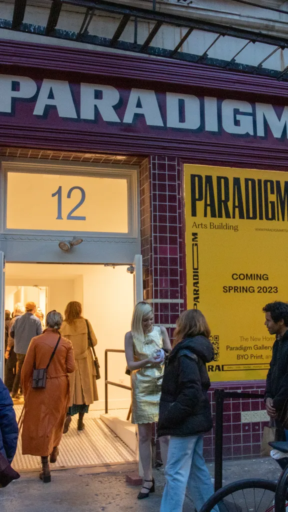 External photo of Paradigm Gallery with attendees entering 