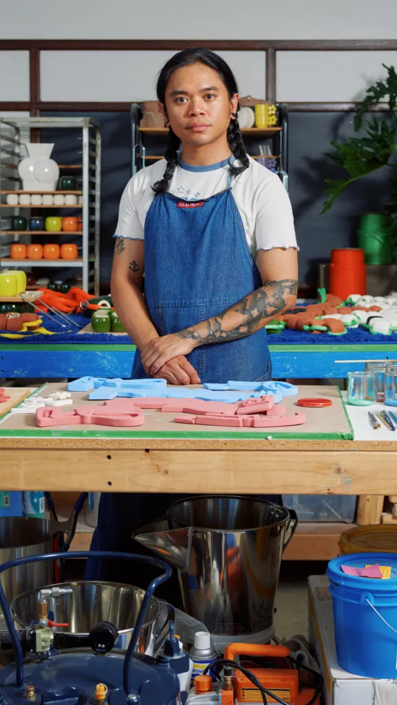 Ceramicist Jeff Rubio stands in his studio surrounded by works in progress
