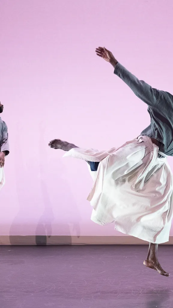 Two dancers jump into the air knowing no bounds, just relief and freedom.