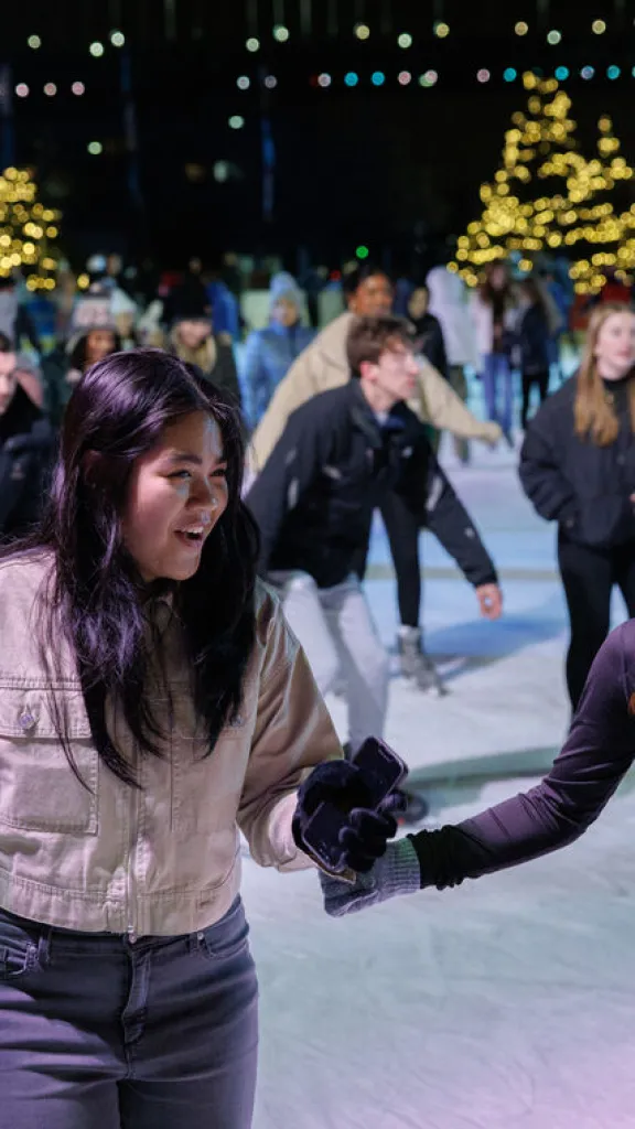 Photo of two girls skating and laughing.