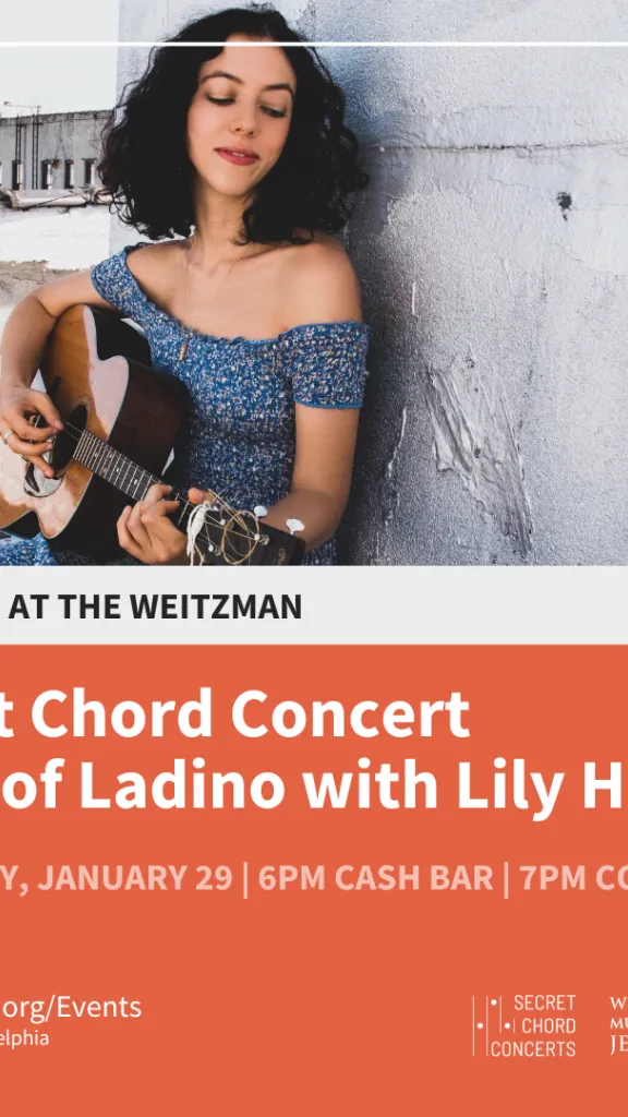 at top there is a light skinned woman with dark curly hair playing a guitar sitting next to a gray concrete wall