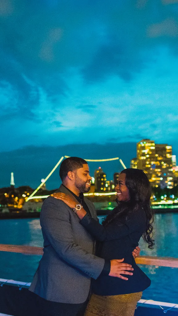 Couple on outer deck of vessel.