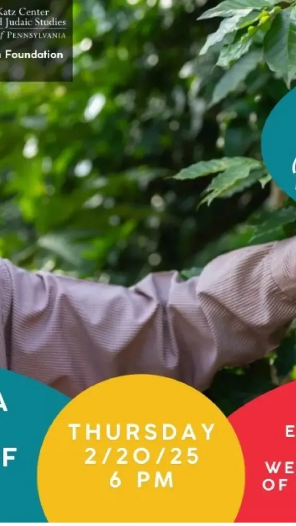 a black man with a blue kippah touches green leaves