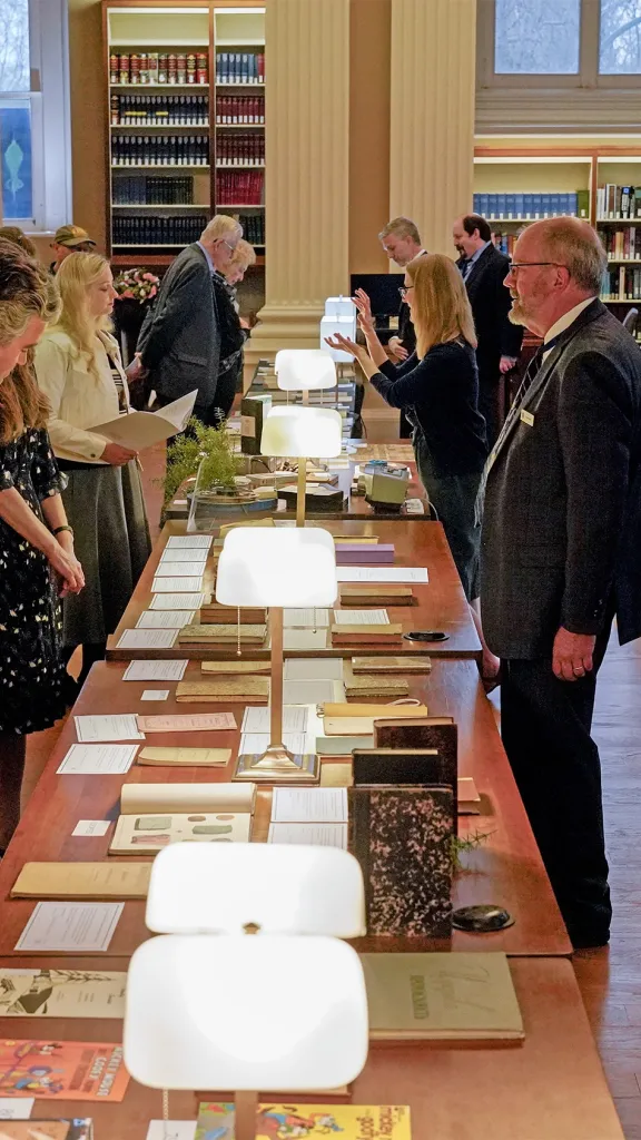 gathering in library looking at book displays