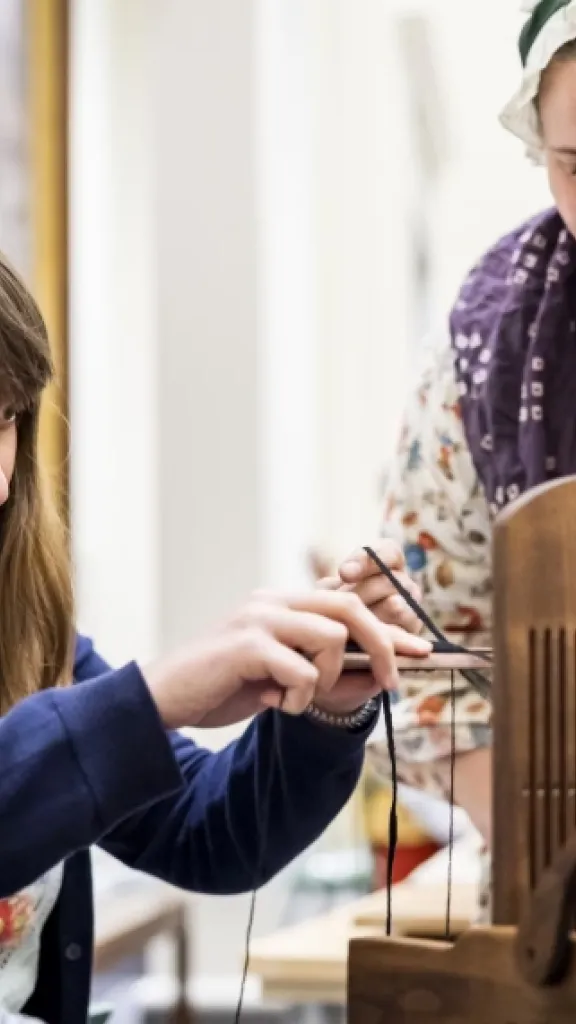 A living history interpreter and a woman at a colonial trade demonstration. Credit MOAR