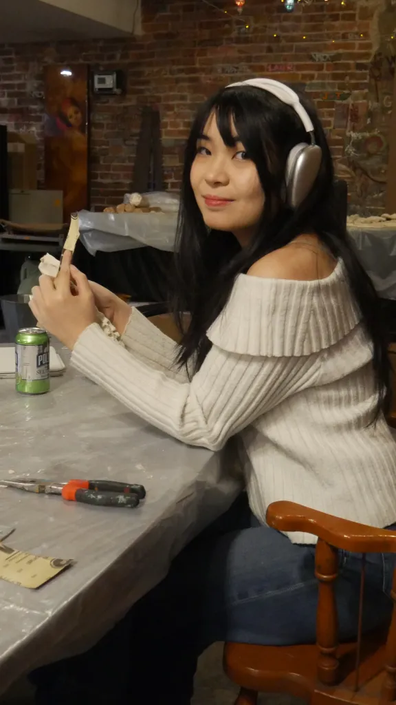 Image of Ministry of Awe First Friday participant, sitting at a table and making art.