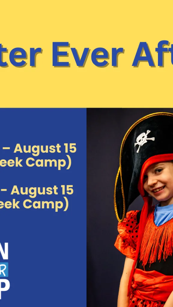 A girl dressed as a pirate with a large pirate hat smiles at the camera.