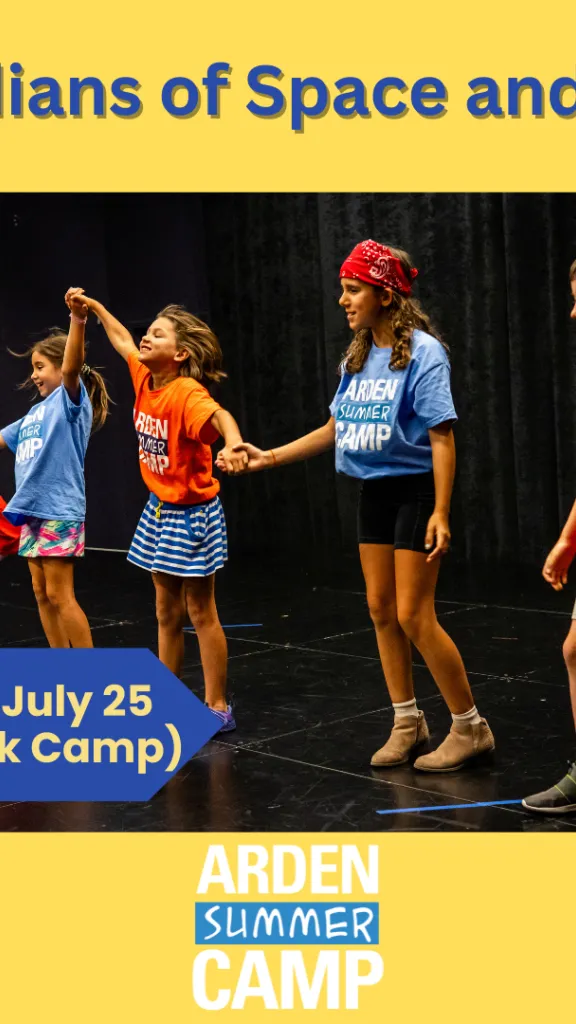 Children on the stage performing a play, some of them holding hands and making a wave while smiling.