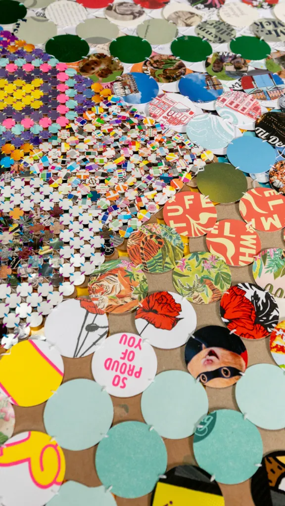 Close-up of hand-sewn circles cut from everyday materials