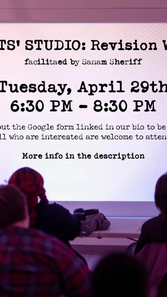 A group of people seated before a white screen projection with details of this event (in the event description)