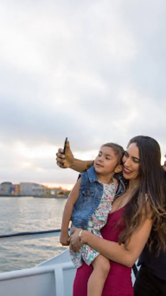 Family posing for a photo while aboard City Cruises 