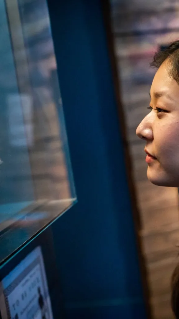 Visitor looking at Phillis Wheatley's book of poetry