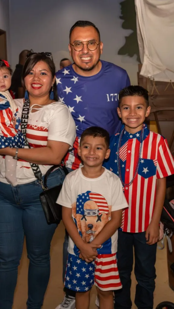Family of five  dressed up in red, white, and blue celebrating the 4th of July at The Weitzman