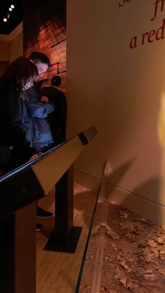 Museum visitor reads Finding Freedom exhibit kiosk.