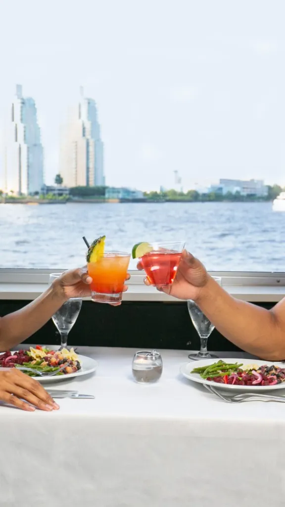 Couple toasting drinks on boat