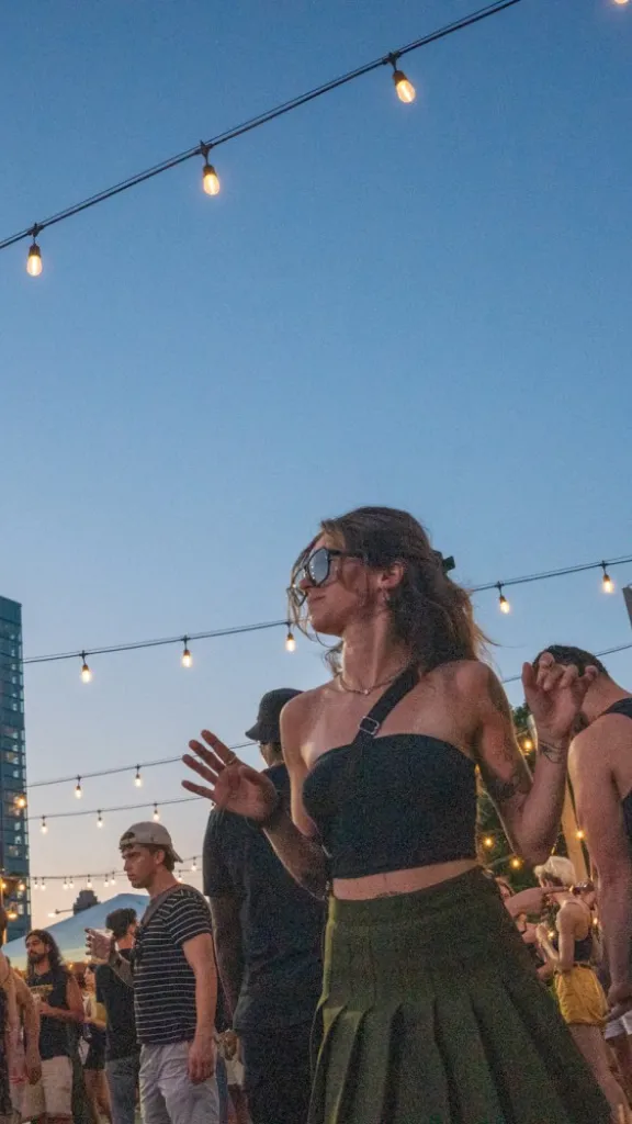 Crowd dancing under the lights at Spruce Street Harbor Park