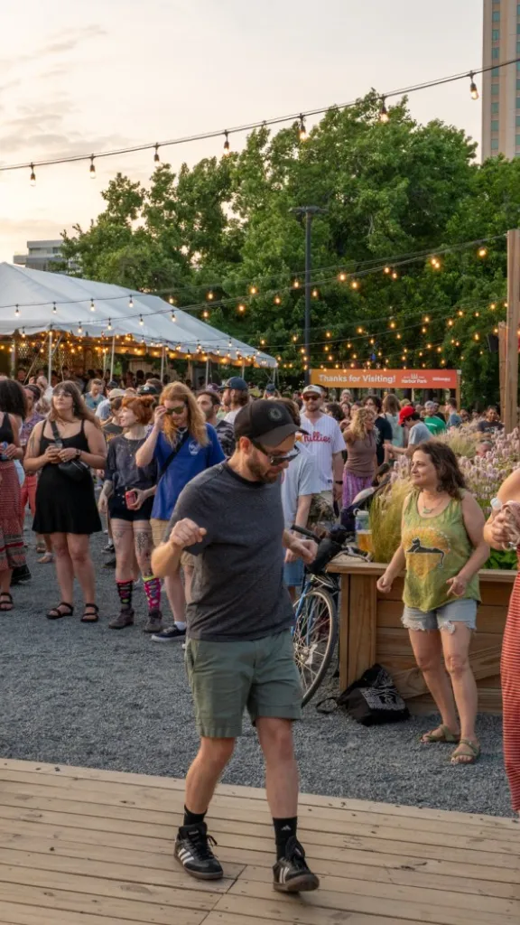 People dancing and listening to music at the Lazy Hammock stage at Spruce Street Harbor Park.