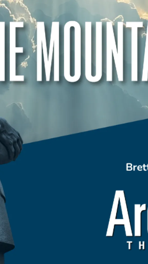 A stone statue figure resembling Martin Luther King, Jr. standing in front of a cloudy background. Text Reads: The Mountaintop, By Katori Hall Directed by Brett Ashley Robinson, Arden Theatre Co. 