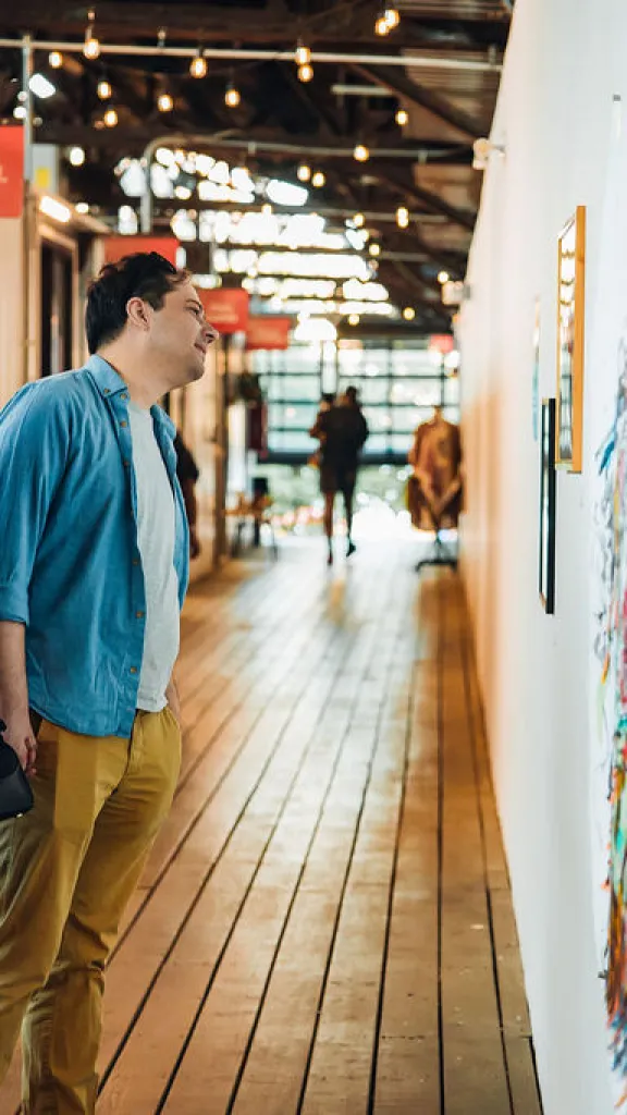 Vistors viewing artwork on First Friday at Cherry Street Pier