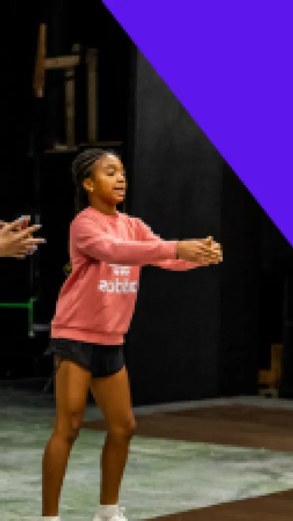 Three students hold the same pose as they learn and show a dance. Two more students do the same behind them. Text that reads "One Day Workshop" and "Grades 6-8"