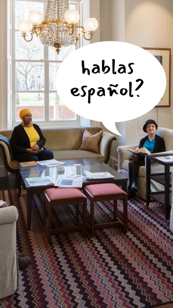 People sit in the Athenaeum Member Lounge speaking Spanish